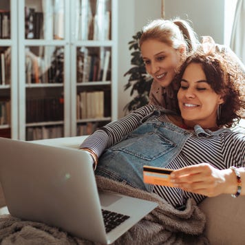Close up of a female couple online shopping on their laptop