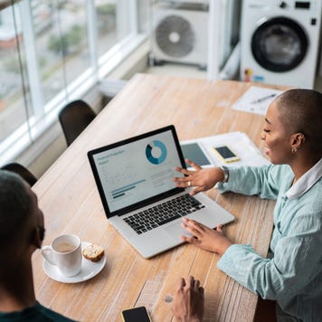 Financial advisor or real estate agent talking to customer at home