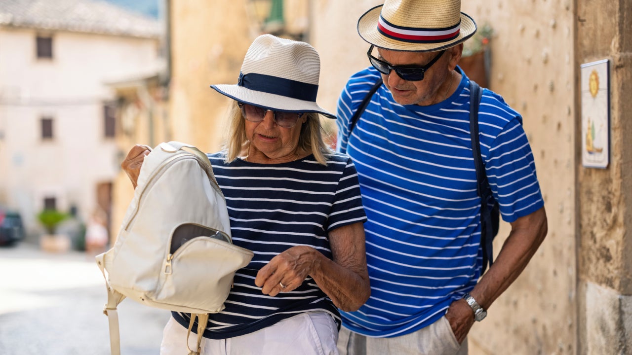 Senior tourist couple discovering missing wallet