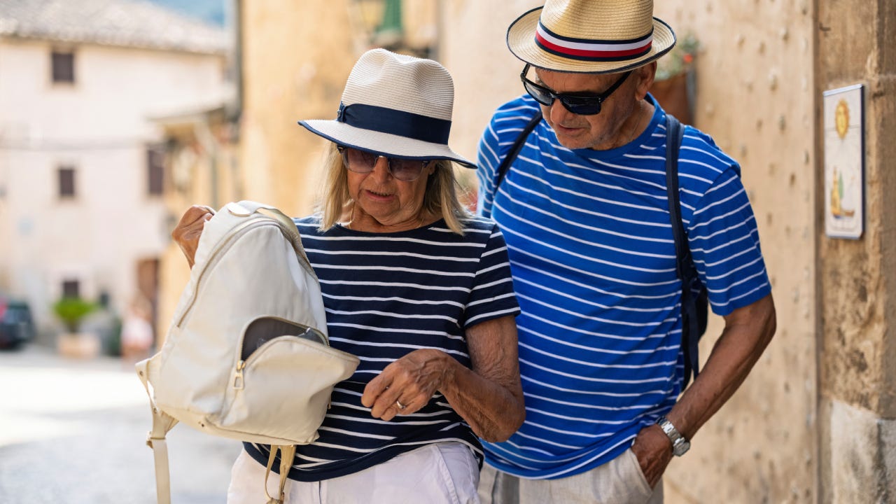 Senior tourist couple discovering missing wallet