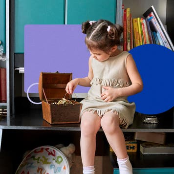 Child going through an old box of jewelry.