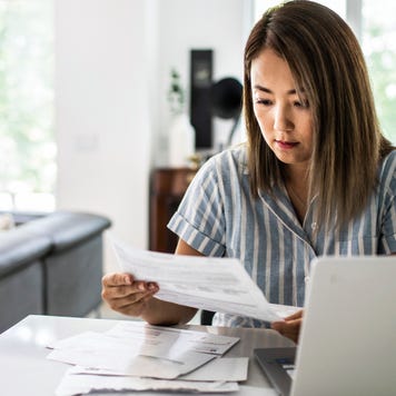 Woman paying bills at home
