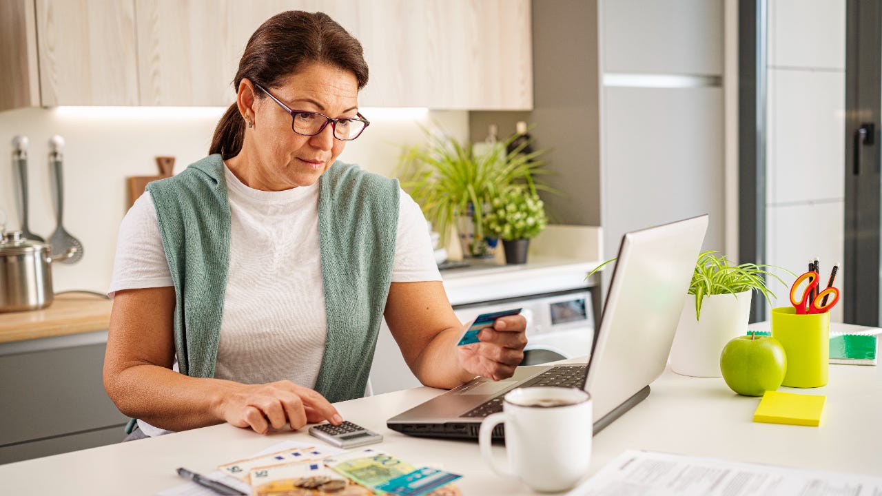Concentrated woman calculating home expenses