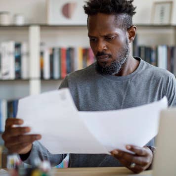 Man looking over paperwork at home