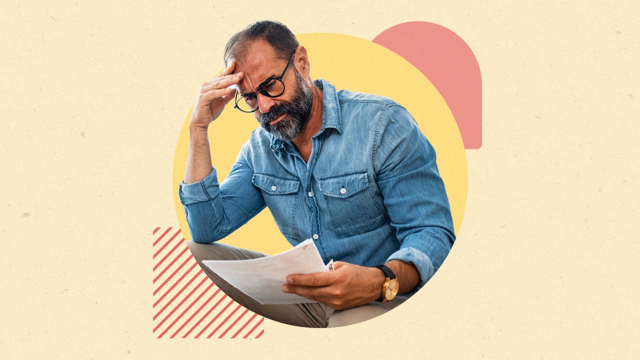 Pensive man in glasses reading paper with geometric design behind him.