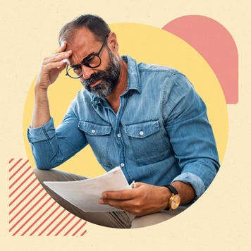 Pensive man in glasses reading paper with geometric design behind him.