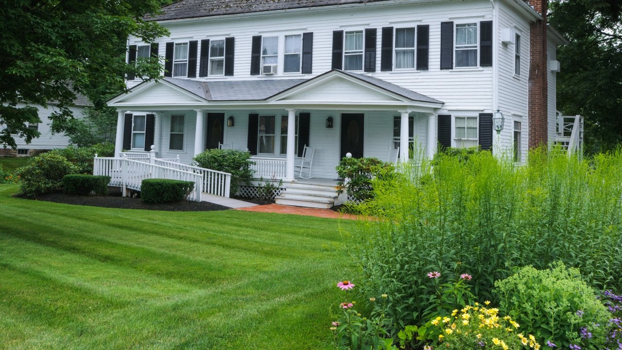 A white house with a big garden and a handicapped entrance