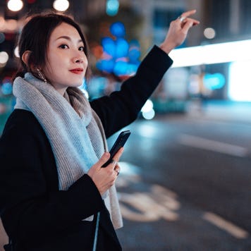 Young Woman With Smartphone waiting for Lyft ride