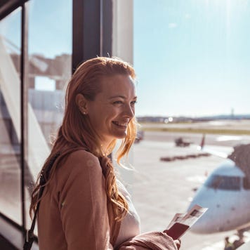 Young woman waiting to board the airplane