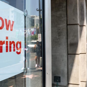 Now hiring sign in a shop window