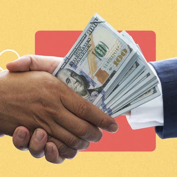A hand shake, with money in one hand