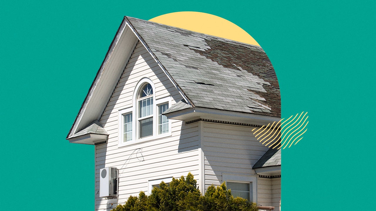 Photo of a house with old roofing tiles that need to be replaced.