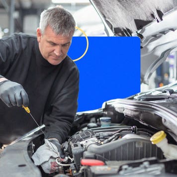 A mechanic works on a car.