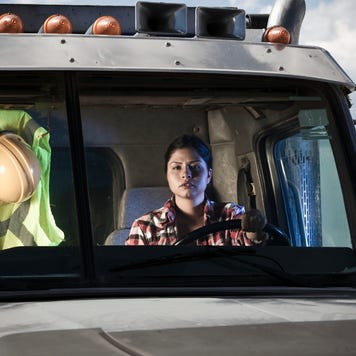 A female truck driver in her semi.