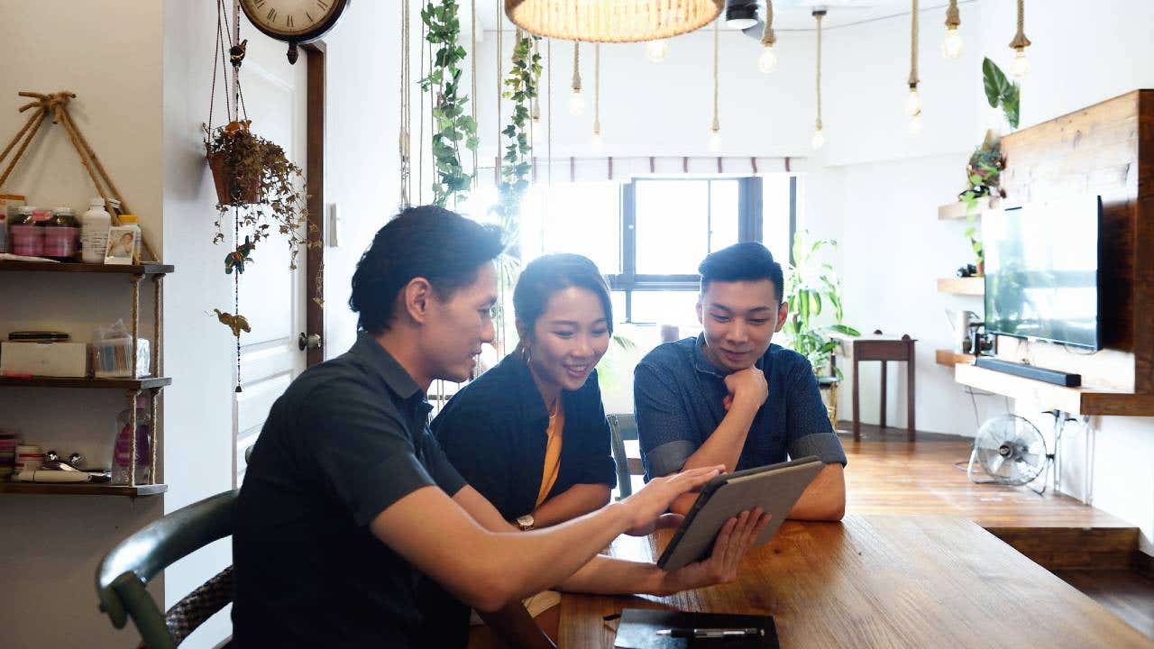 Young couple with a financial advisor at home