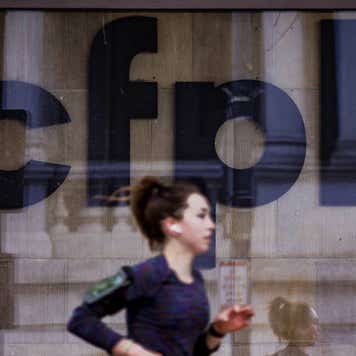 A jogger runs past CFPB building