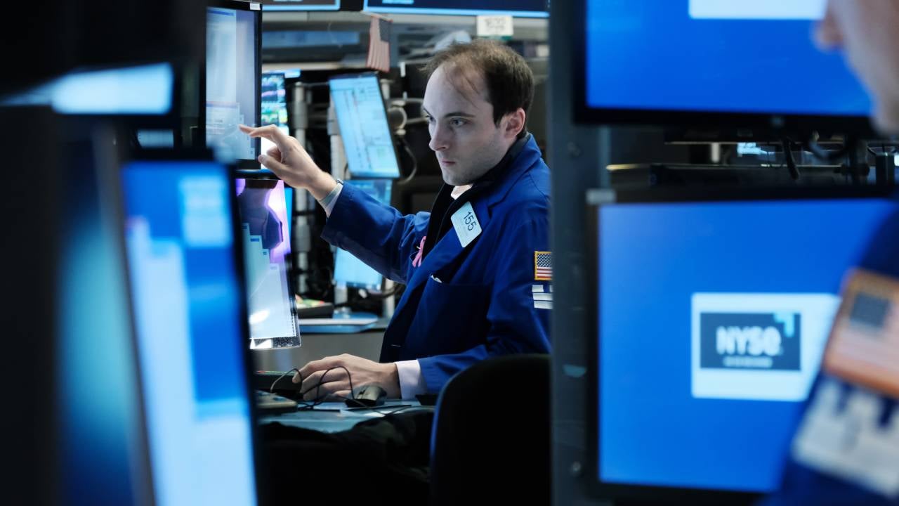 Traders work on the floor of NYSE