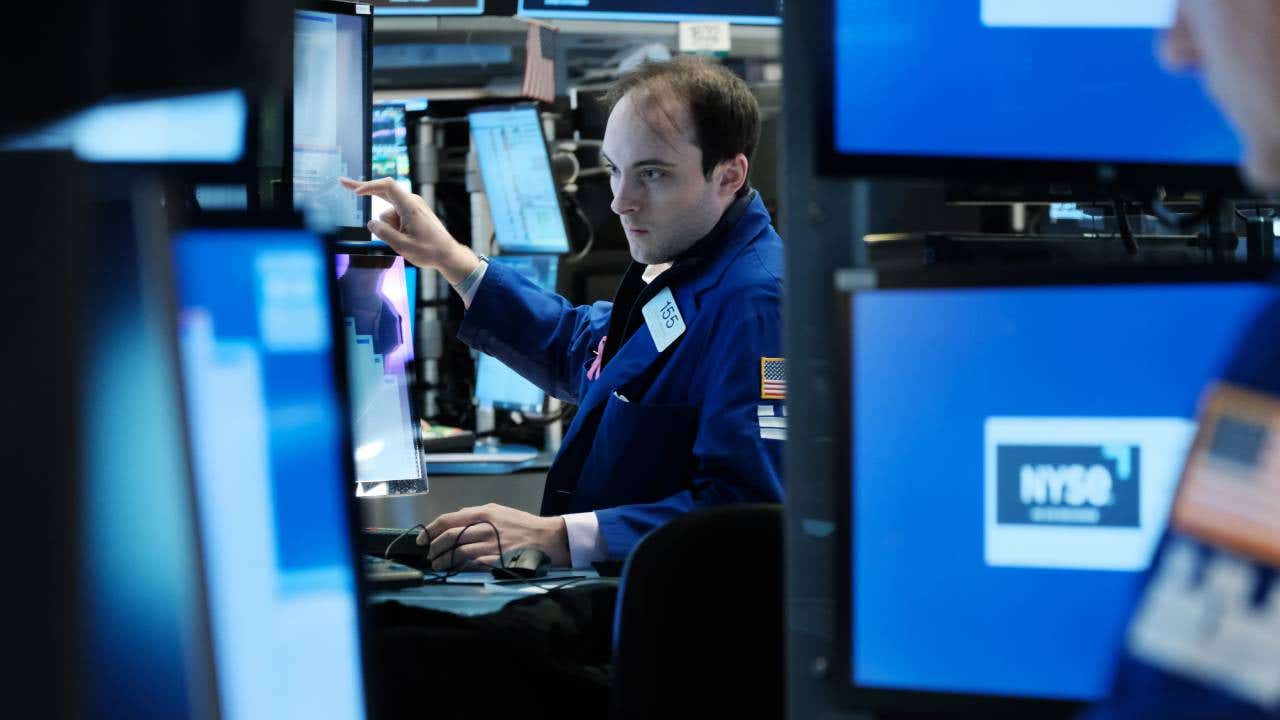 Traders work on the floor of NYSE