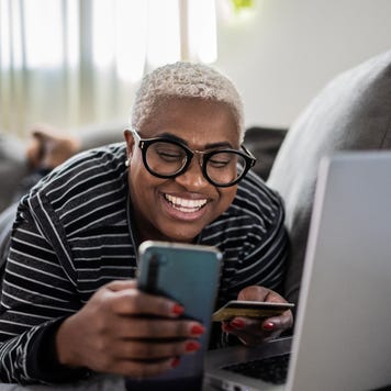 women shopping online using mobile phone at home