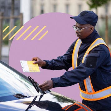 An officer slipping a parking ticket under a car's windshield.