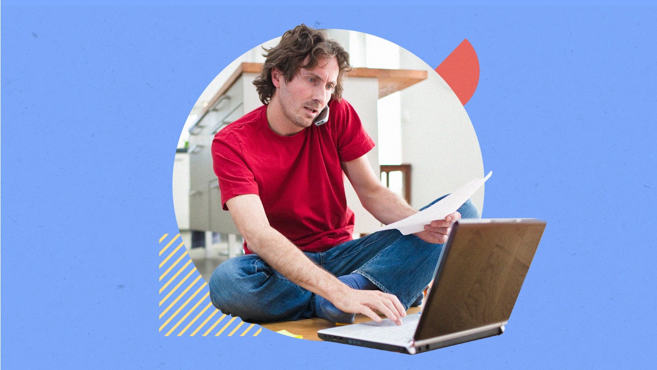 White man works on laptop while talking on a cellphone