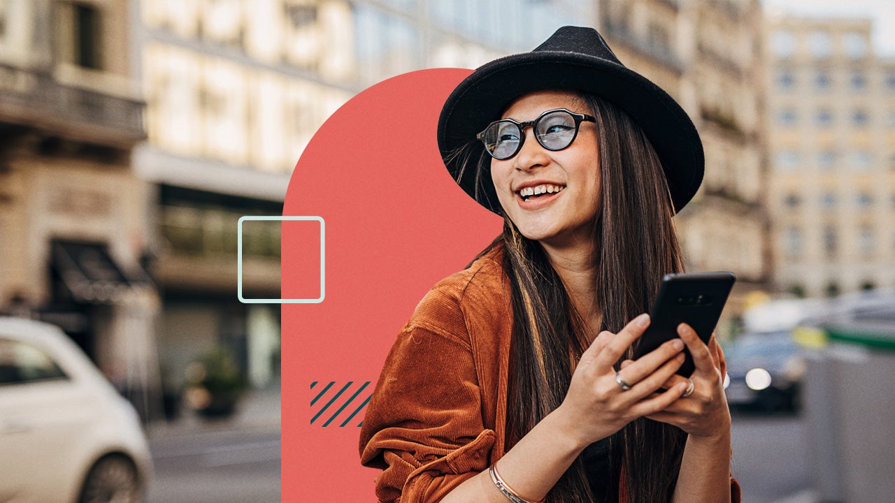 Woman smiling and using a cellphone