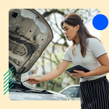 An insurance adjuster inspecting a car with the hood up