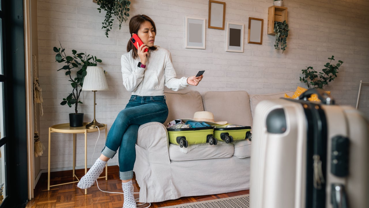 An Asian female tourist in hotel having problems paying with credit card