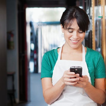 Waitress texting in hallway