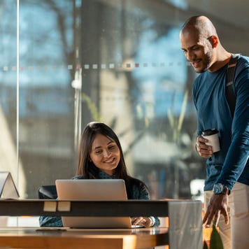 Two coworkers sharing an interaction in a nice office building