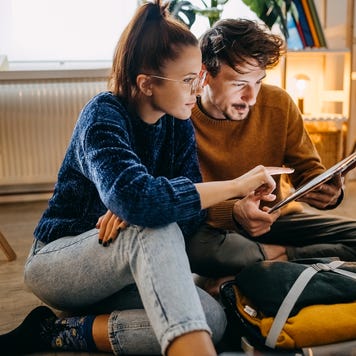 Couple planning vacation trip and searching information on tablet