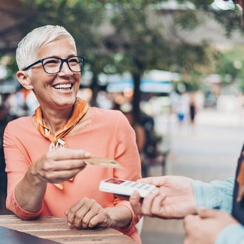 Senior woman paying with a credit card