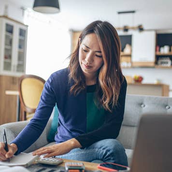 Young woman doing her finances at home