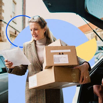 Woman holding boxes and reading a piece of paper