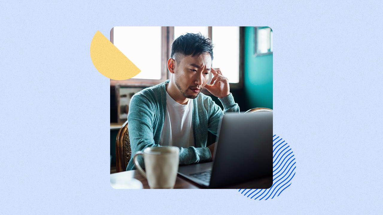 Man at laptop looking stressed