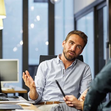 coworkers discussing during meeting in office