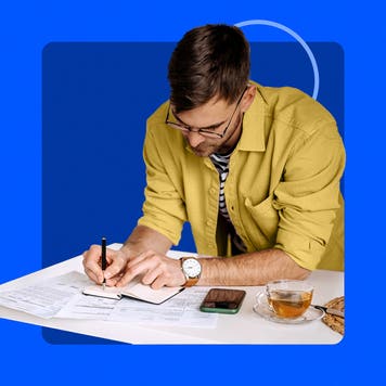 man working on financial paperwork, blue background