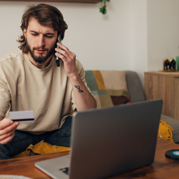 Man having problem with credit card, using mobile phone, dissatisfied male using internet banking service, checking balance, loss money, internet fraud and scam concept