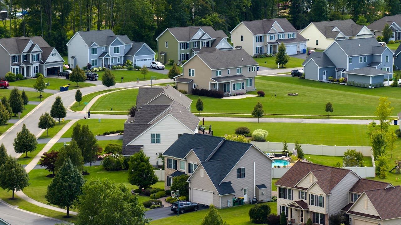 suburban neighborhood with trees and green grass