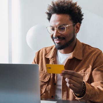 Smiling businessman making payment with credit card