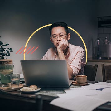 Man lost in thought as he sits at his office desk