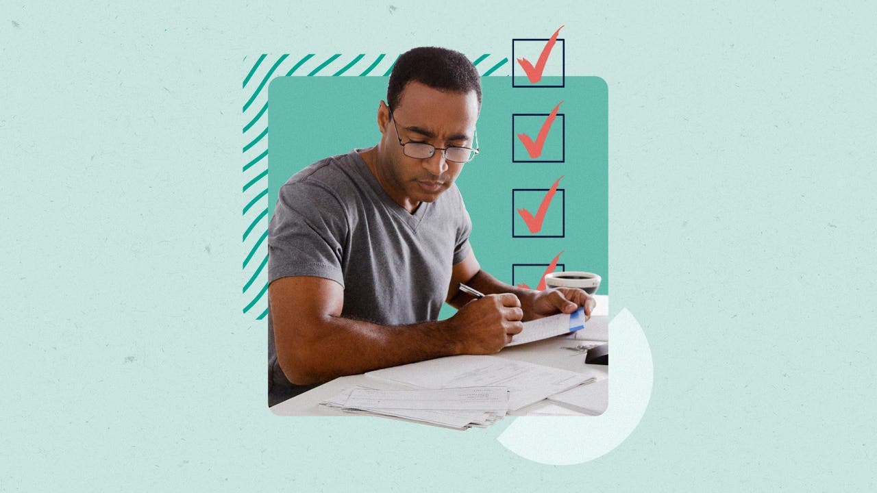 A man sitting in front of a stack of papers