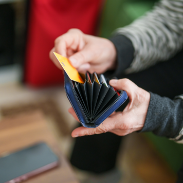 Senior woman making online shopping with her credit card on mobile phone