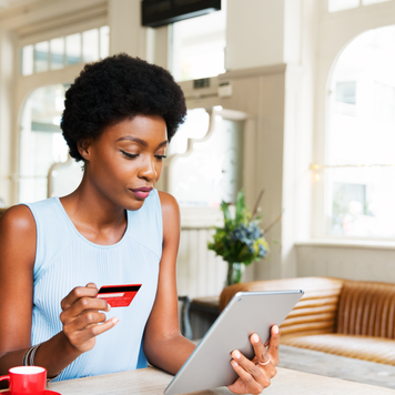 Woman with credit card and tablet