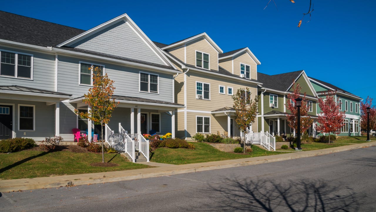 A neighborhood of row houses of various styles and colors in Hinesburg, Vermont.