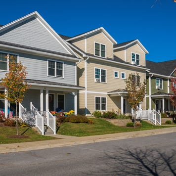 A neighborhood of row houses of various styles and colors in Hinesburg, Vermont.