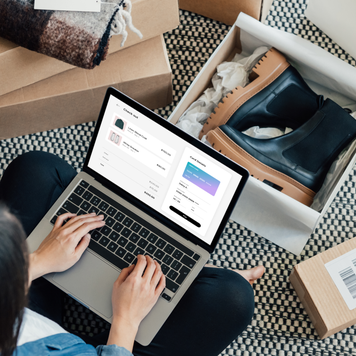 High angle view of young woman making credit card payment while doing online shopping on laptop. Technology makes shopping easier. Mockup image for woman doing online shopping.