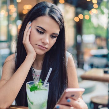 Depressed woman drinking mojito