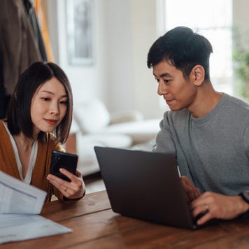 Young Asian couple going through home finances