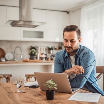 Man using laptop in kitchen